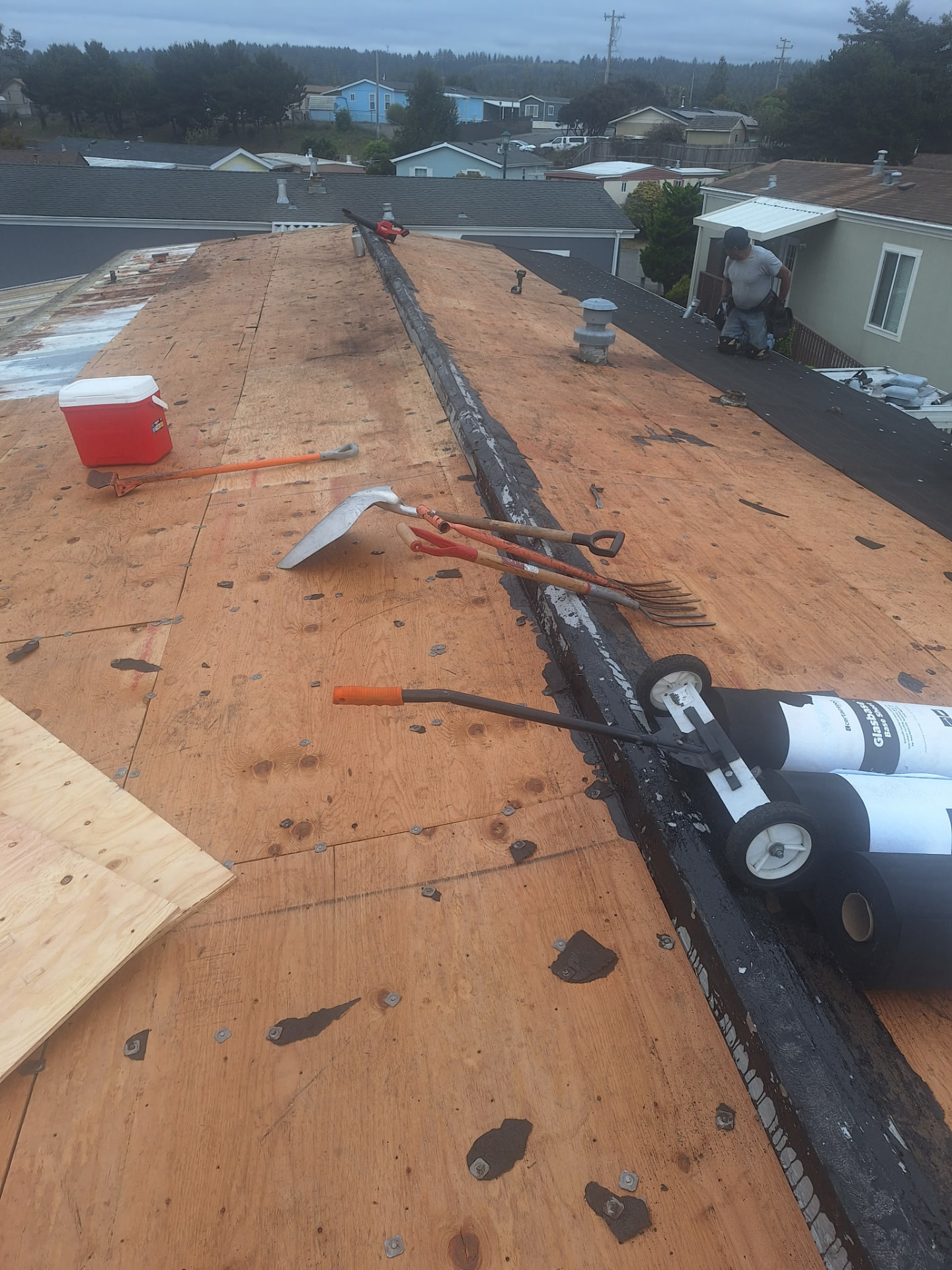 Tear-Off — The old roofing comes off, down to the bare deck.